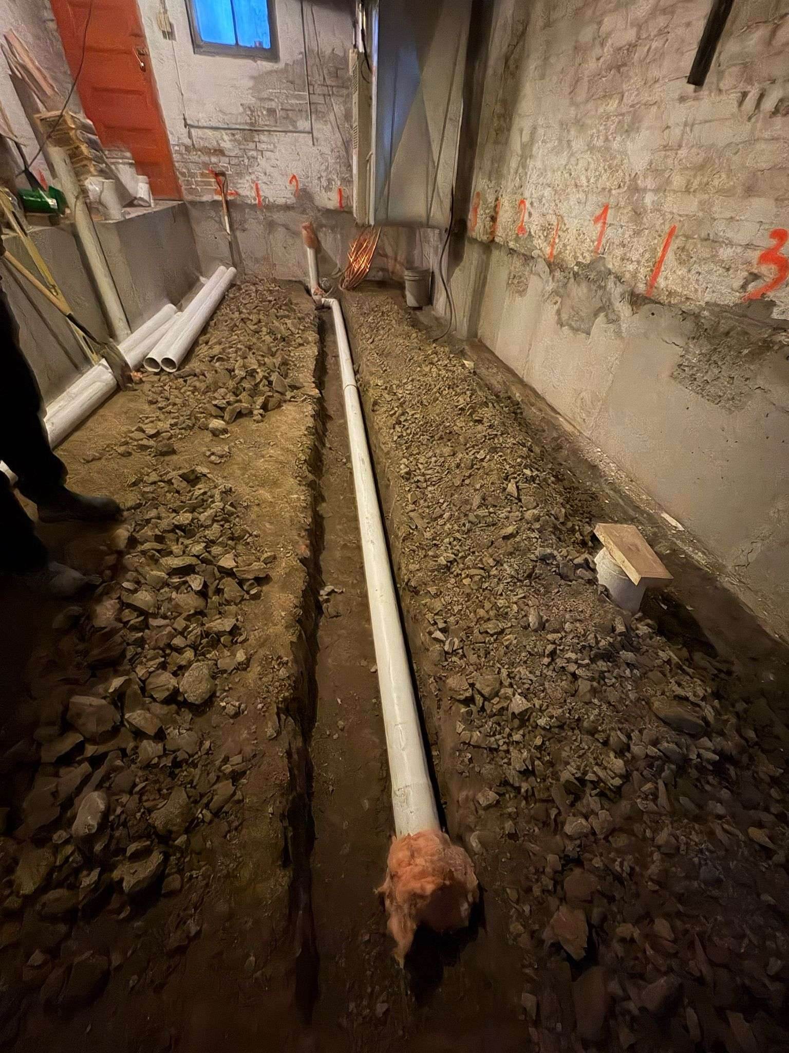 New under-slab drain pipe installed in a lowered Toronto basement