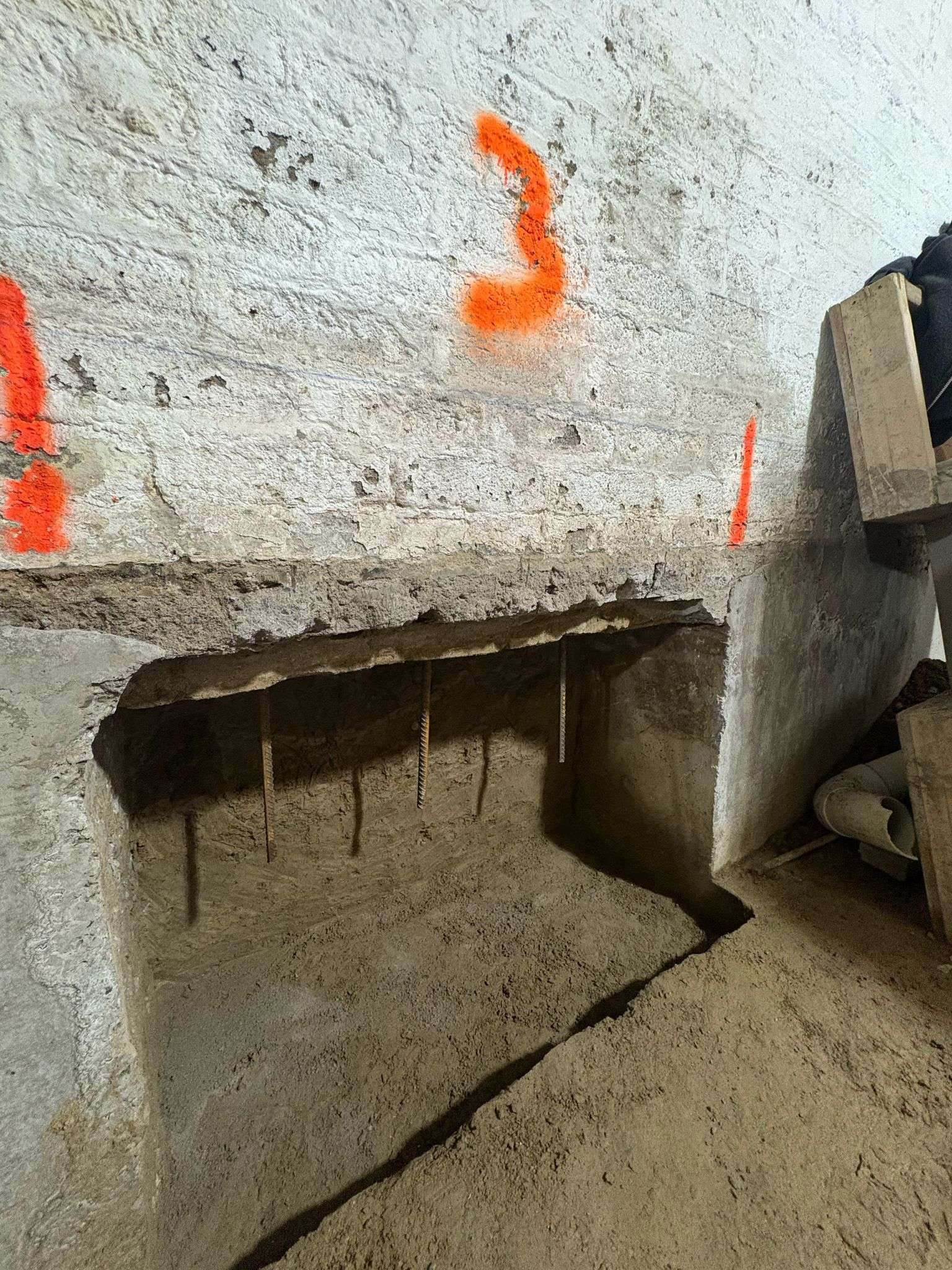 Close-up of an underpinning pin excavated below an existing footing