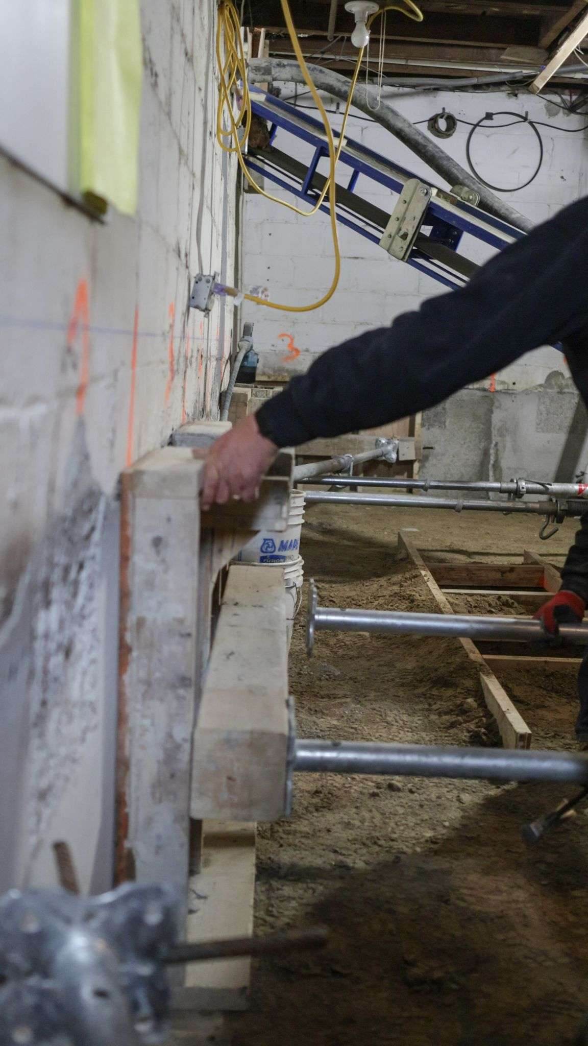 Steel shoring posts supporting a basement during underpinning